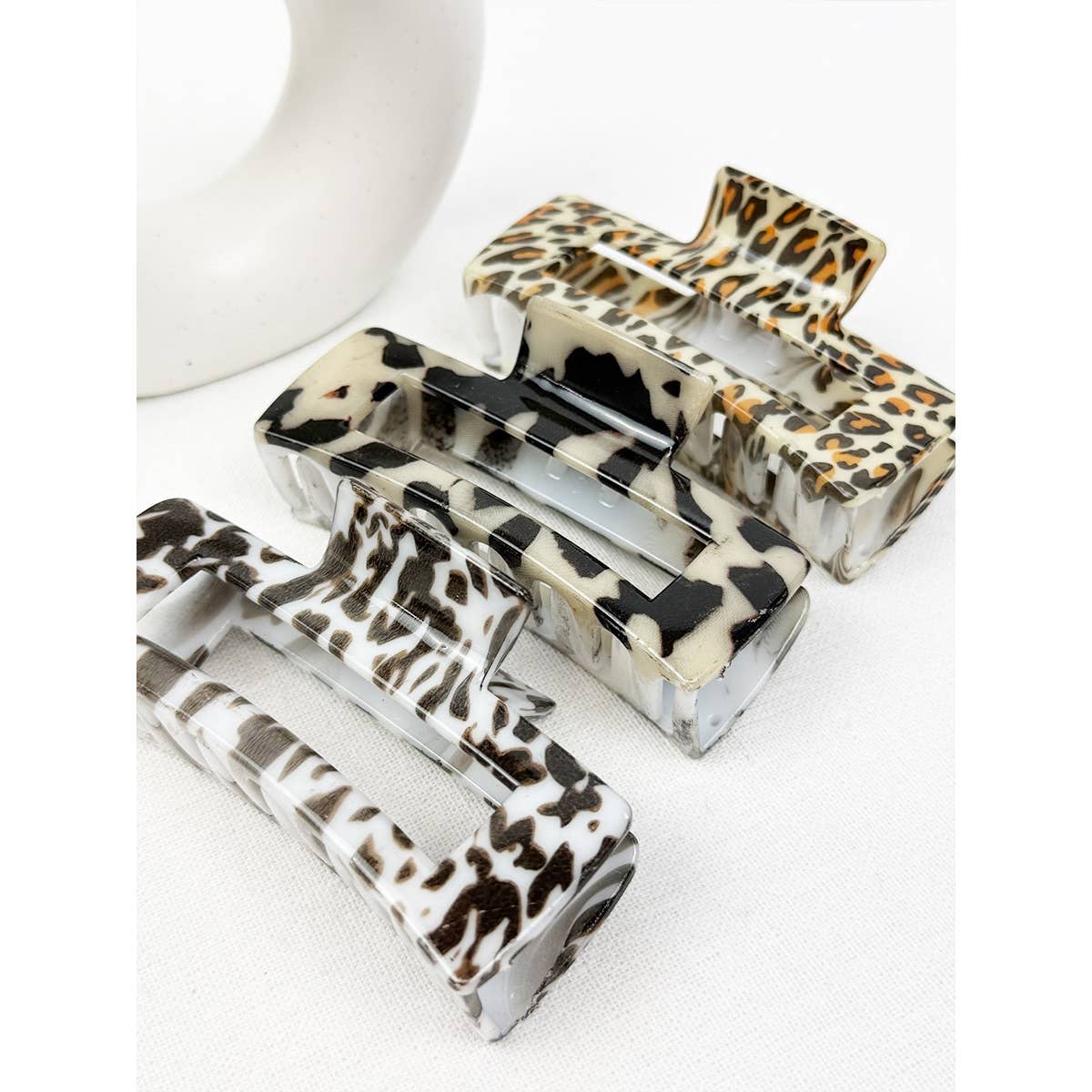 Set of leopard print hair clips on a white background