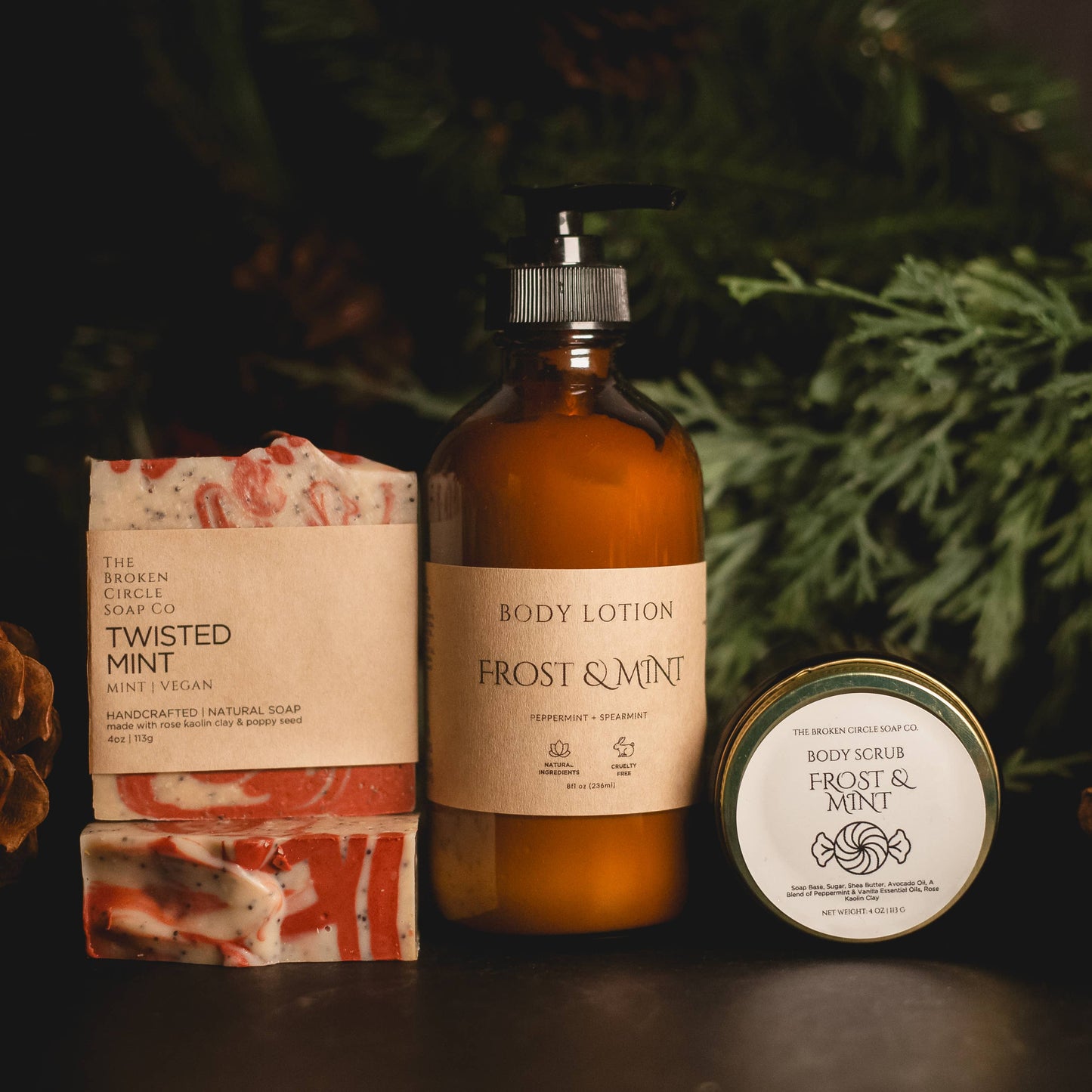 Frost & Mint body lotion, soap, and scrub with a Christmas tree background
