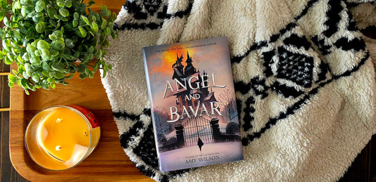 Book on tray with candle ad plant