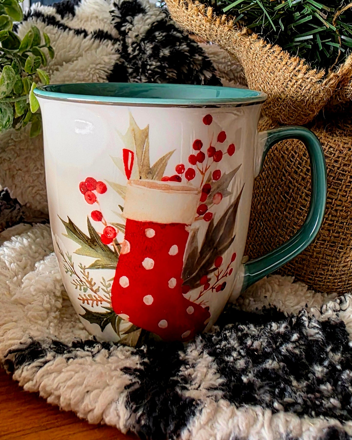 Decorative mug with a red stocking design on a textured surface