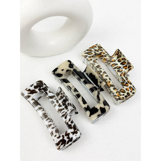 Leopard print hair clips on a white background