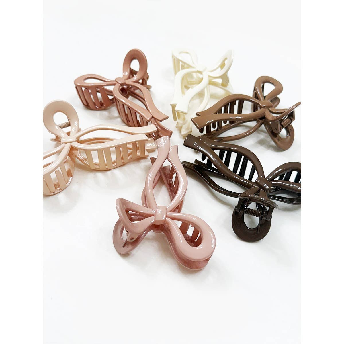 Set of four hair clips in different colors on a white background