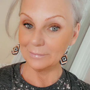 Our beautiful customer wearing our brown, black and white Aztec earrings. 